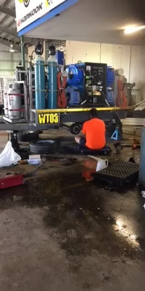 A technician replacing car rims in Mackay