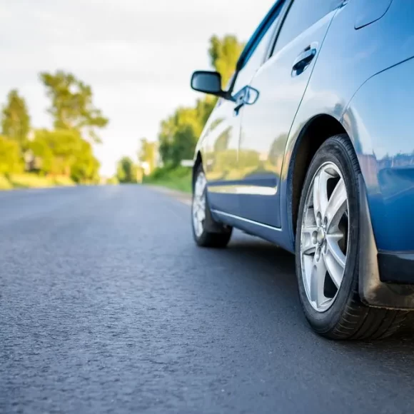 A sedan with new tyre driving on a Mackay street